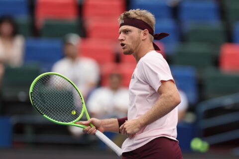 Alejandro Davidovich Fokina, in a pink shirt and maroon headband, holds his racket during a match at the Shanghai Masters