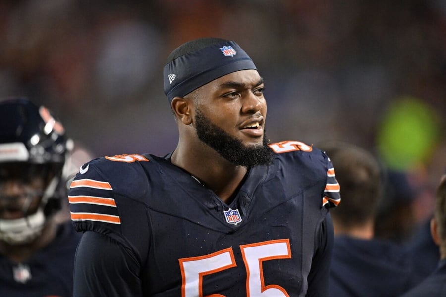 Chicago Bears defensive end Dayo Odeyingbo in a navy number 55 jersey and headband looks on from the sideline