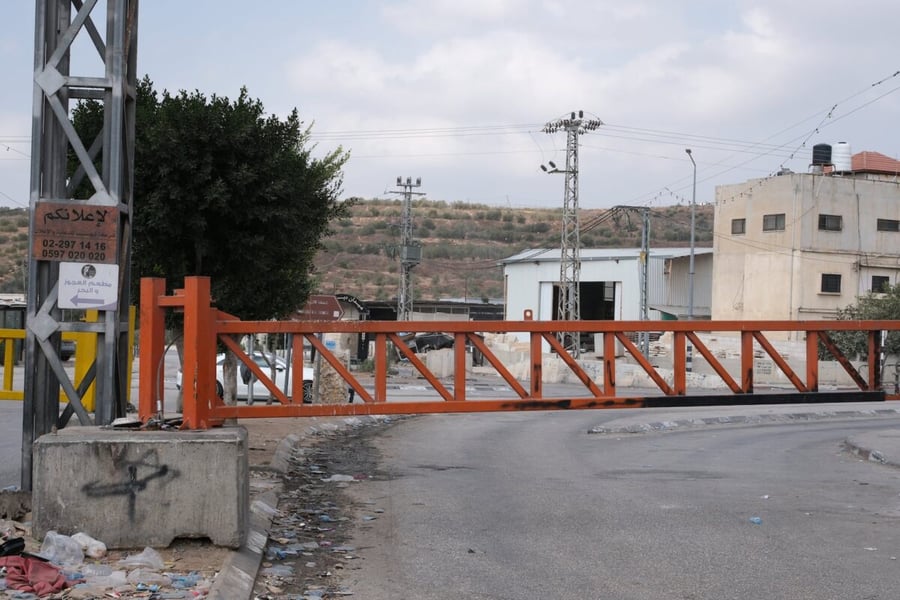 An orange road barrier set up by Israeli security forces in Dayr Sharraf, near Nablus