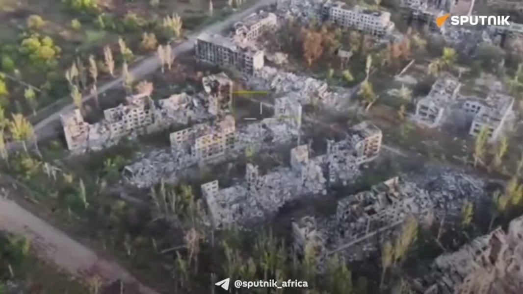 Aerial drone view of ruined apartment blocks among trees in Dobropolye, from footage released by the Russian Defence Ministry
