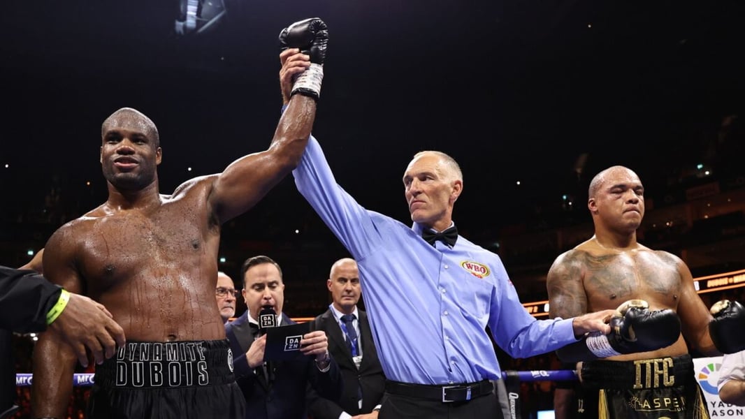 Daniel Dubois has his hand raised in victory beside Fabio Wardley after their WBO heavyweight rematch
