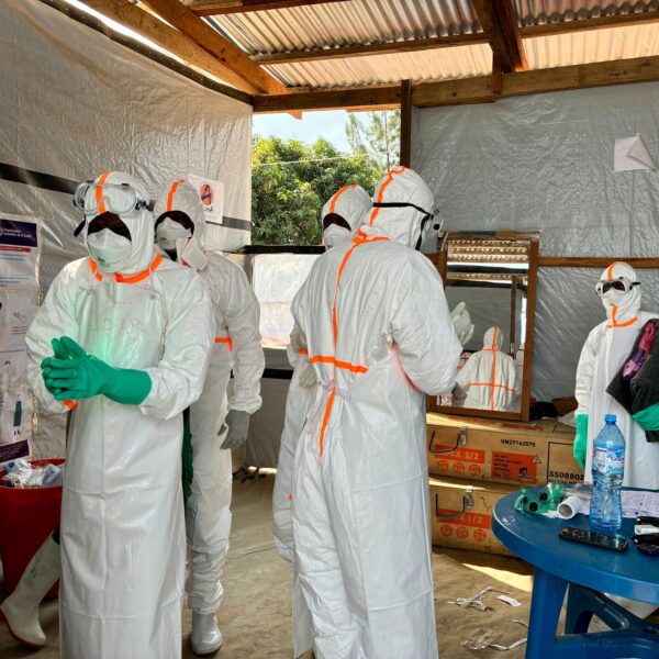 Health workers in white protective suits, goggles and masks prepare inside a tented Ebola treatment centre in Bunia, Ituri province