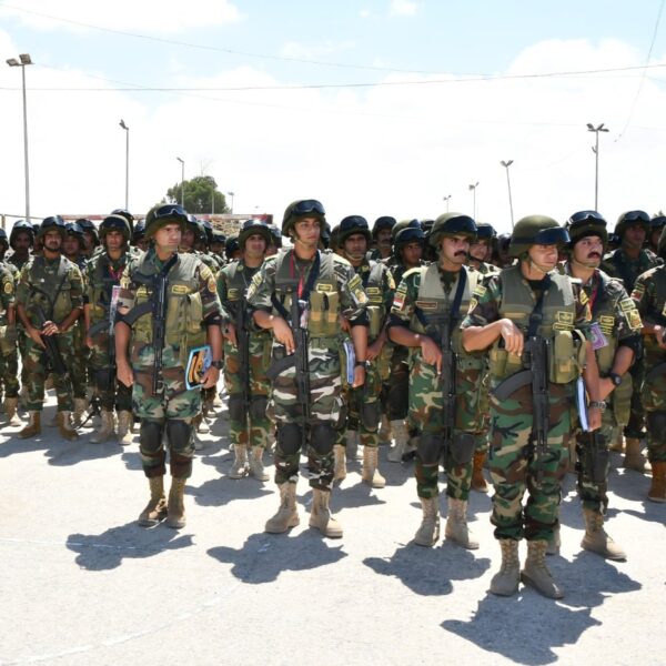 Rows of Egyptian soldiers in helmets and camouflage standing in formation on a paved parade ground