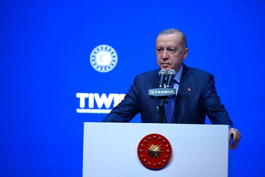 President Recep Tayyip Erdogan speaking at a podium bearing the presidential seal