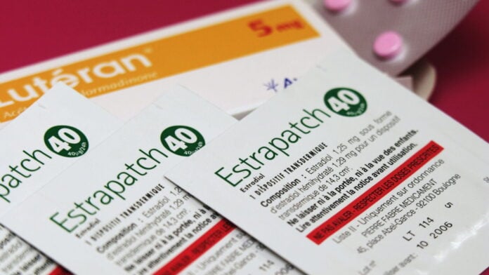 Packets of Estrapatch 40 estradiol transdermal patches lying on a box of a progestogen tablet in a file photo
