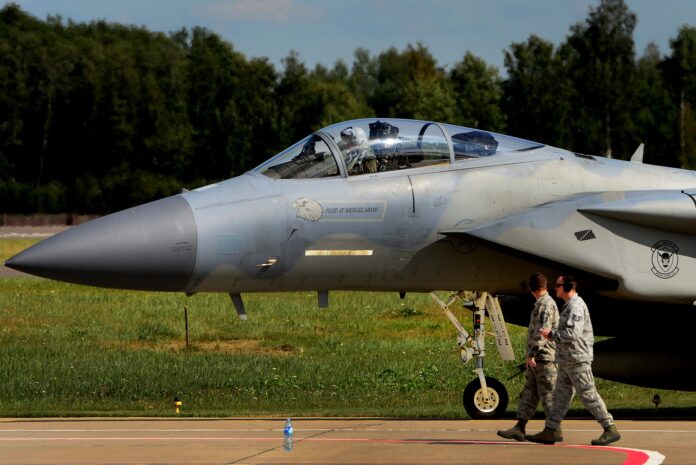 A U.S. Air Force F-15C Eagle taxis past two airmen at Siauliai Air Base, Lithuania, in a 2017 file photo