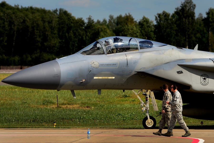 A U.S. Air Force F-15C Eagle taxis past two airmen at Siauliai Air Base, Lithuania, in a 2017 file photo