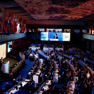 FAO Director-General Qu Dongyu speaks from a podium in the plenary hall at FAO headquarters in Rome during World Food Day 2026