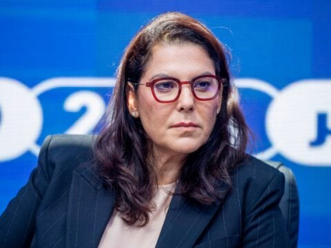 Fatima Ezzahra El Mansouri, Morocco's first woman prime minister, seated against a blue backdrop