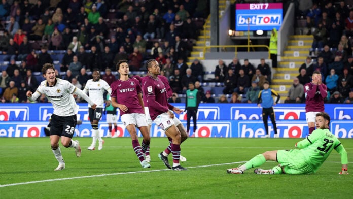 Wolves forward Fer Lopez wheels away in celebration after scoring at Turf Moor as Burnley defenders and goalkeeper Gregoire Coudert look on