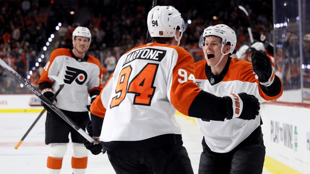 Philadelphia Flyers forward Porter Martone, number 94, celebrates with a teammate on the ice