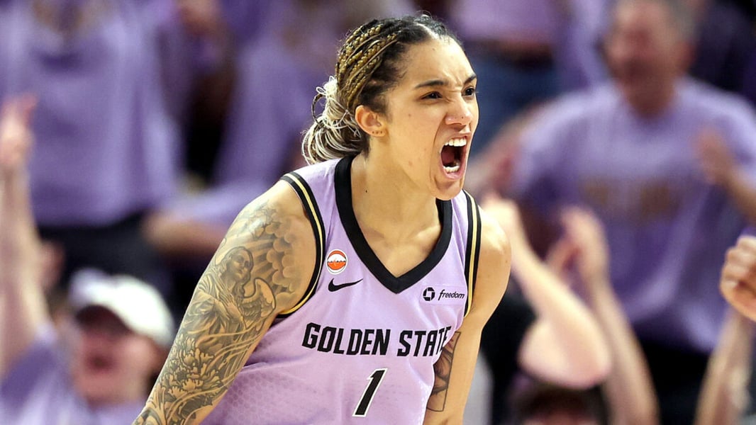 Gabby Williams of the Golden State Valkyries shouts in a purple number 1 jersey in front of a crowd