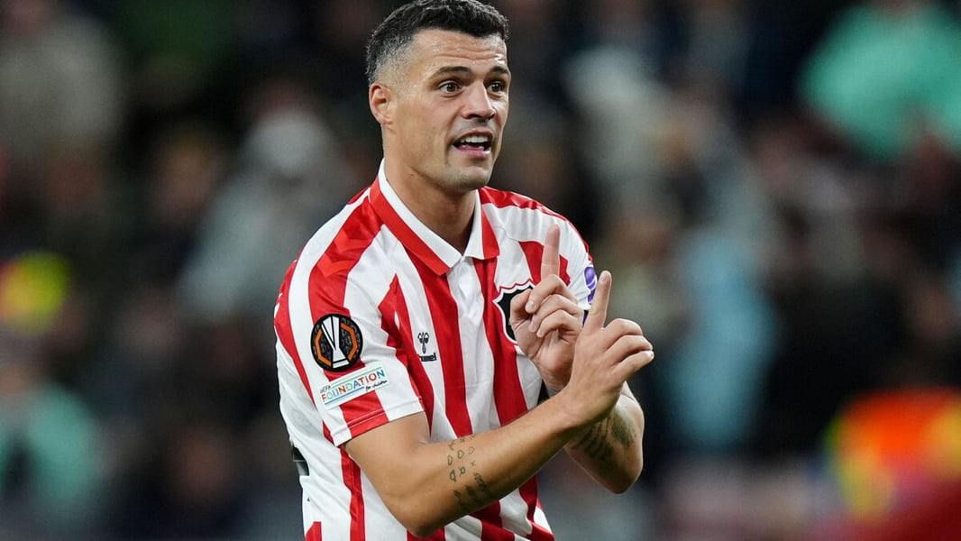 Sunderland midfielder Granit Xhaka gestures during a Europa League match in a red and white striped shirt