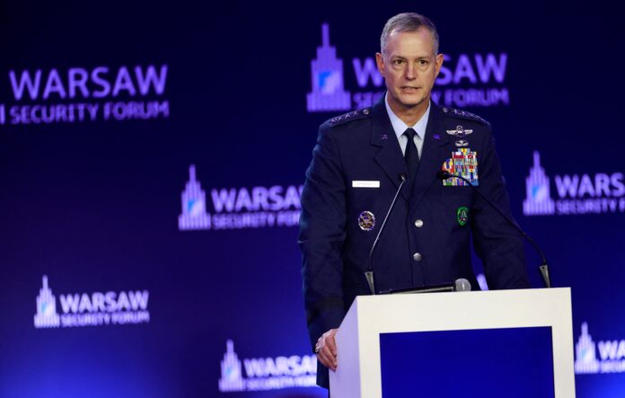 US Gen. Alexus Grynkewich speaking at a podium in front of Warsaw Security Forum banners