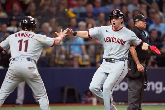 José Ramírez and Chase DeLauter celebrate after scoring on Nathaniel Lowe’s eighth-inning single against the Tampa Bay Rays.