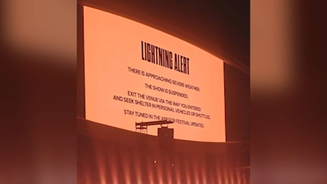 A large illuminated lightning alert sign at the Head Trip festival in Indio, telling attendees the show is suspended and to seek shelter
