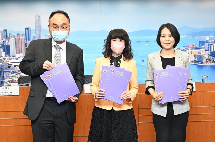 Hong Kong Government Economist Irina Fan and two colleagues holding copies of the Half-yearly Economic Report 2026