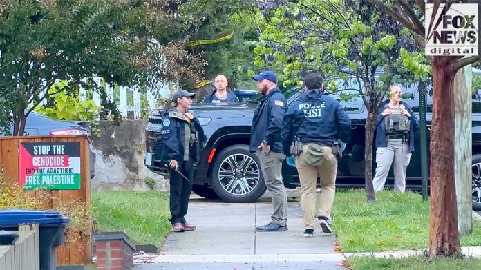 Homeland Security Investigations agents standing on a sidewalk outside Rep. Ilhan Omar's Washington home during the search