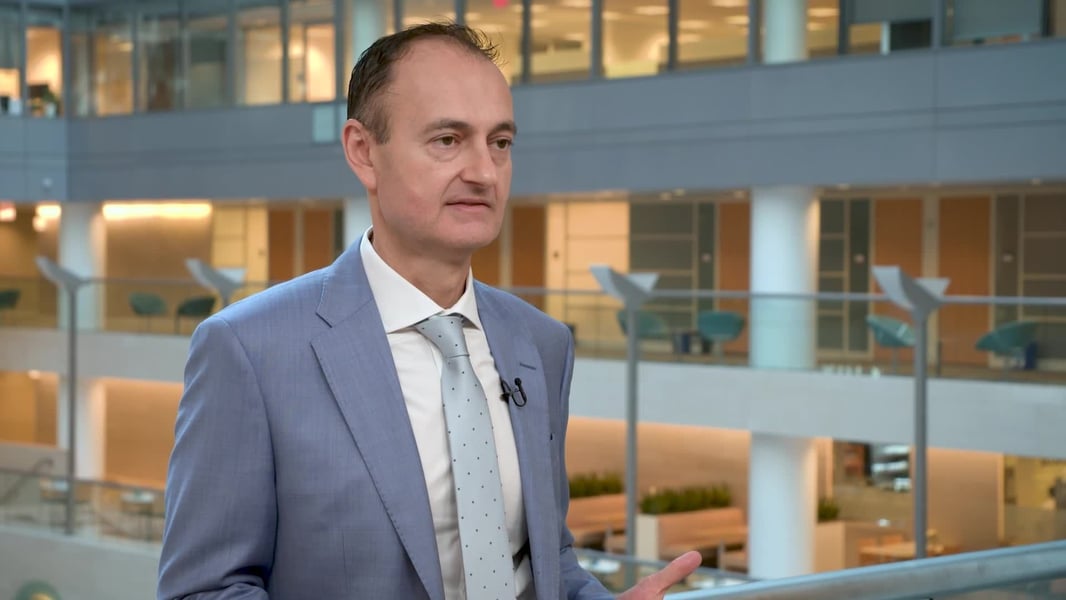 An IMF official speaking in an office atrium in the IMF's video release of the October 2026 Global Financial Stability Report