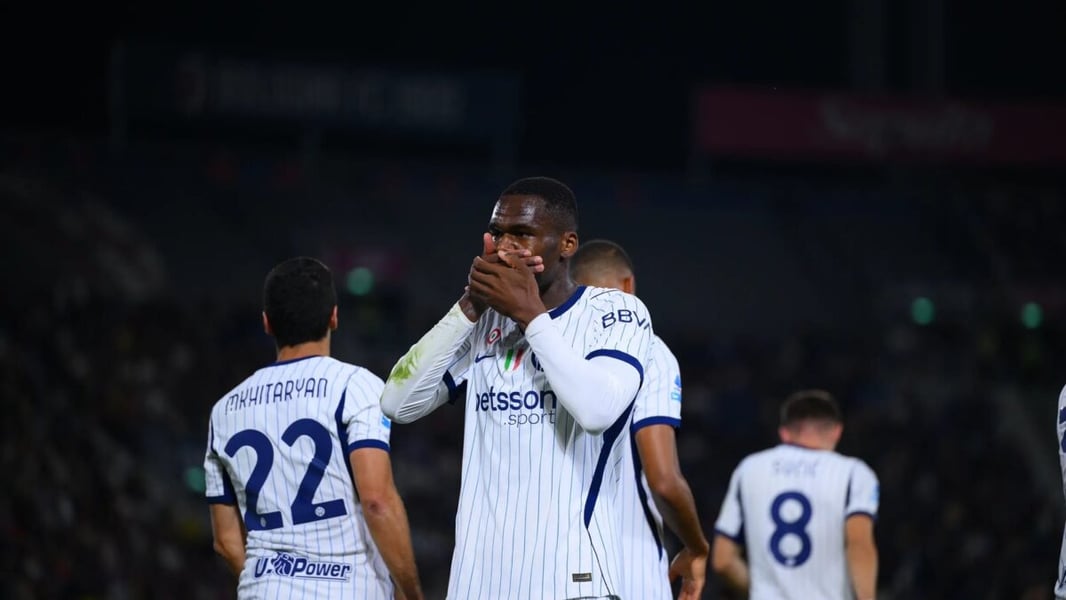 Inter striker Ange-Yoan Bonny covers his mouth with both hands as he celebrates his goal at Bologna