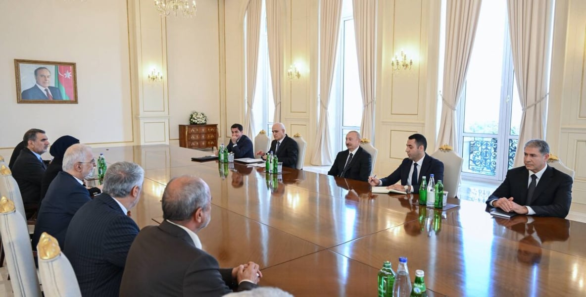 Iranian and Azerbaijani delegations seated along a long table during Ilham Aliyev's meeting with Iran's Interior Minister Eskandar Momeni in Baku