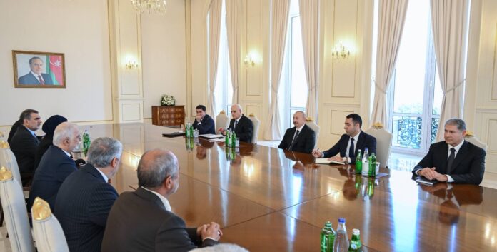 Iranian and Azerbaijani delegations seated along a long table during Ilham Aliyev's meeting with Iran's Interior Minister Eskandar Momeni in Baku