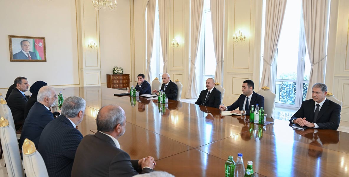 Iranian and Azerbaijani delegations seated along a long table during Ilham Aliyev's meeting with Iran's Interior Minister Eskandar Momeni in Baku