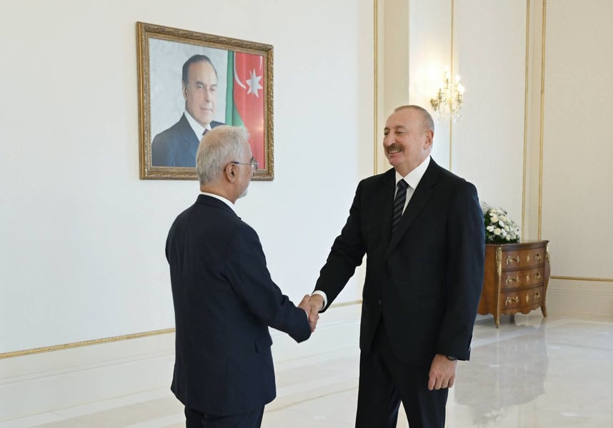 Iran's Interior Minister Eskandar Momeni shakes hands with Azerbaijan's President Ilham Aliyev in Baku