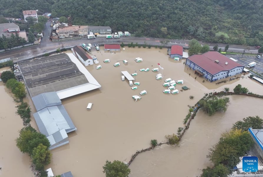 Aerial drone view of brown floodwater covering industrial yards and roads in Sariyer district, Istanbul