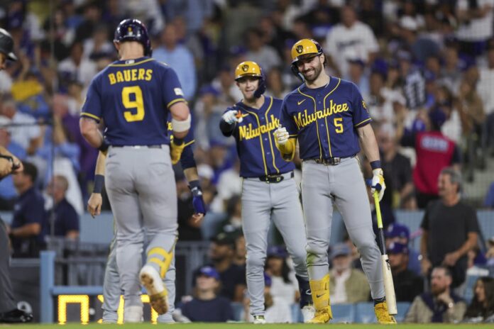 Milwaukee Brewers first baseman Jake Bauers walks toward teammates during Game 3 of the NLCS at Dodger Stadium