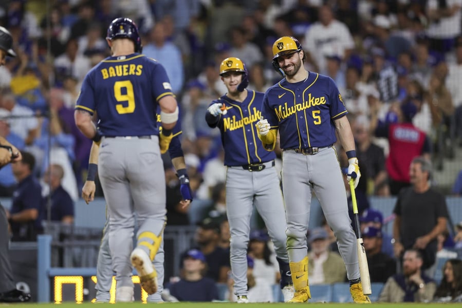 Milwaukee Brewers first baseman Jake Bauers walks toward teammates during Game 3 of the NLCS at Dodger Stadium