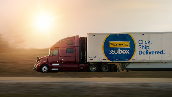 A J.B. Hunt tractor pulling a 360box trailer at sunrise