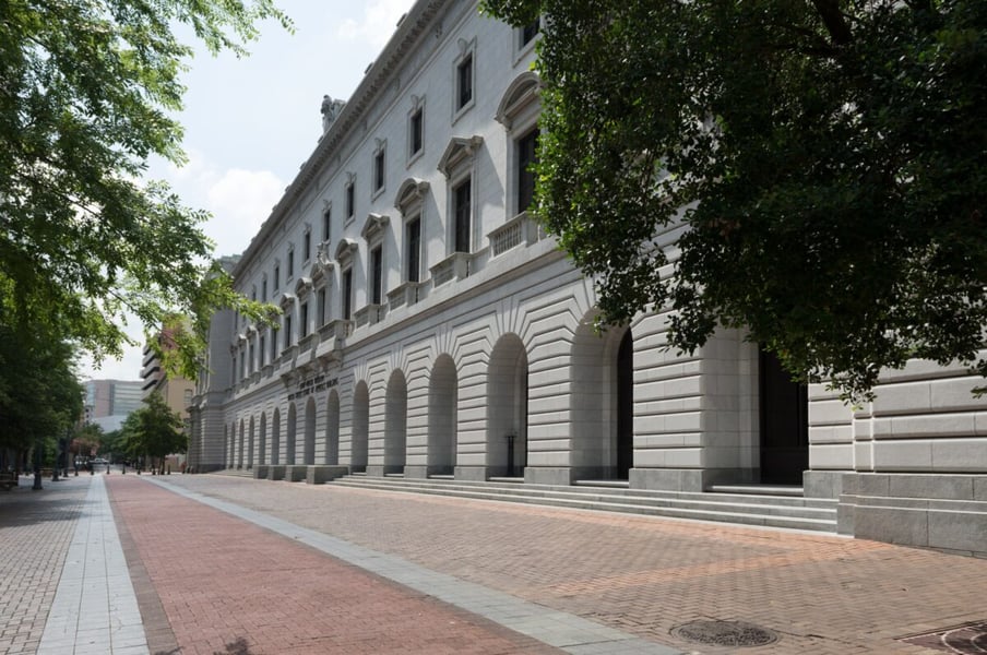 Granite facade and arched arcade of the John Minor Wisdom U.S. Court of Appeals Building in New Orleans