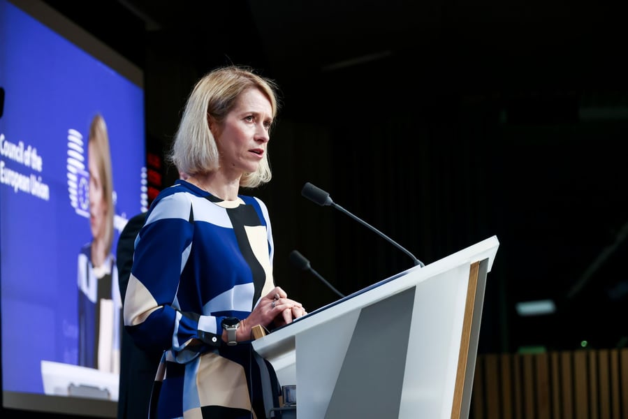 Kaja Kallas speaking at a podium at a Council of the European Union press conference