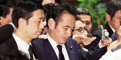 Agriculture Minister Kazuo Yana surrounded by reporters and microphones at the Prime Minister's Office in Tokyo on October 14, 2026