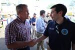 Labor Secretary Keith Sonderling in a Department of Labor polo shakes hands with a man in a plaid shirt at the Fulton County Fair in northwest Ohio