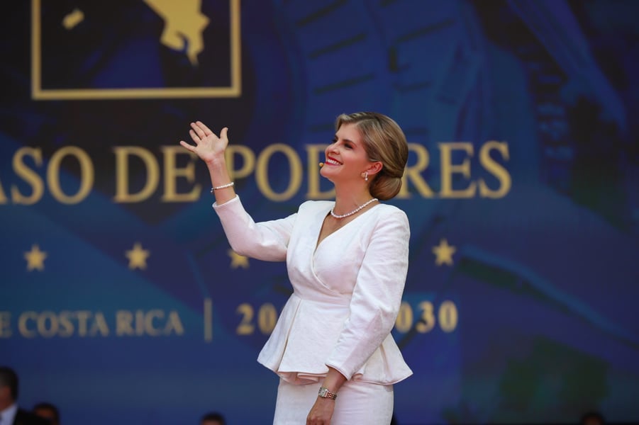 Costa Rican President Laura Fernandez waving on stage at a transfer-of-power ceremony