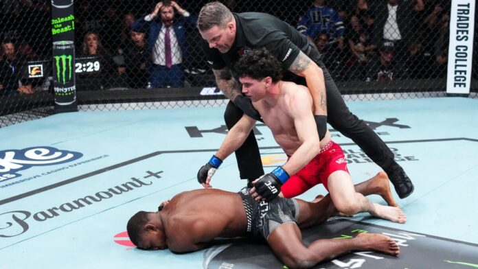 Mike Malott leans over a downed Joaquin Buckley as the referee steps in at UFC Edmonton