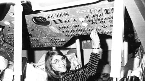 Margaret Hamilton sitting in a mock-up of the Apollo command module at MIT in 1969