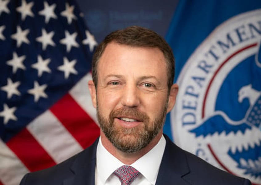 Homeland Security Secretary Markwayne Mullin in an official portrait with the US and Department of Homeland Security flags behind him