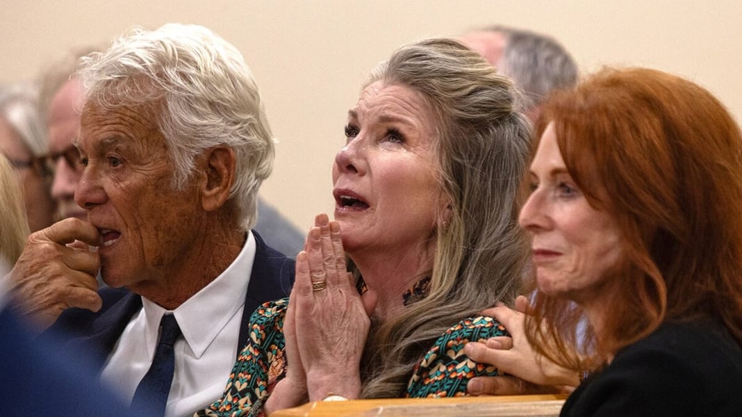 Melissa Gilbert, hands pressed together and in tears, in a Bernalillo County courtroom as a judge releases her husband Timothy Busfield