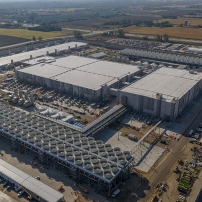Aerial view of a large Microsoft AI datacenter campus with cooling units and adjoining buildings