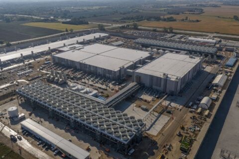 Aerial view of a large Microsoft AI datacenter campus with cooling units and adjoining buildings