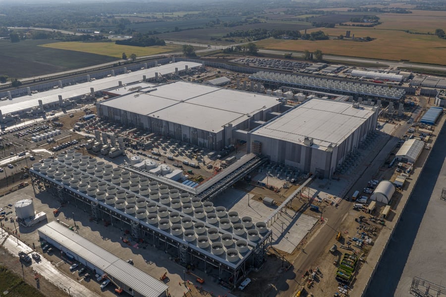 Aerial view of a large Microsoft AI datacenter campus with cooling units and adjoining buildings