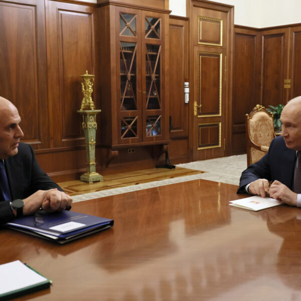 Prime Minister Mikhail Mishustin and President Vladimir Putin seated across a table at the Kremlin