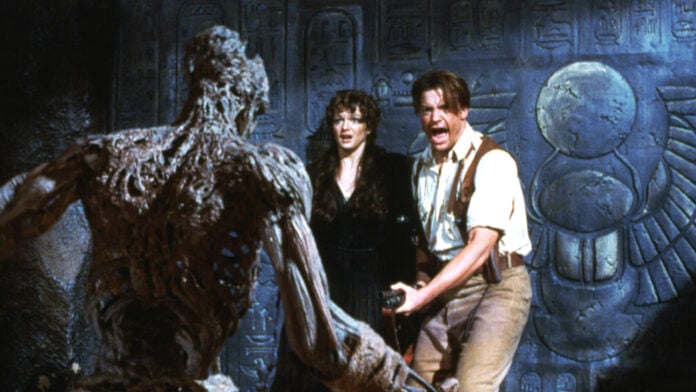 Rachel Weisz and Brendan Fraser recoil from a mummified figure in a scene from the 1999 film The Mummy