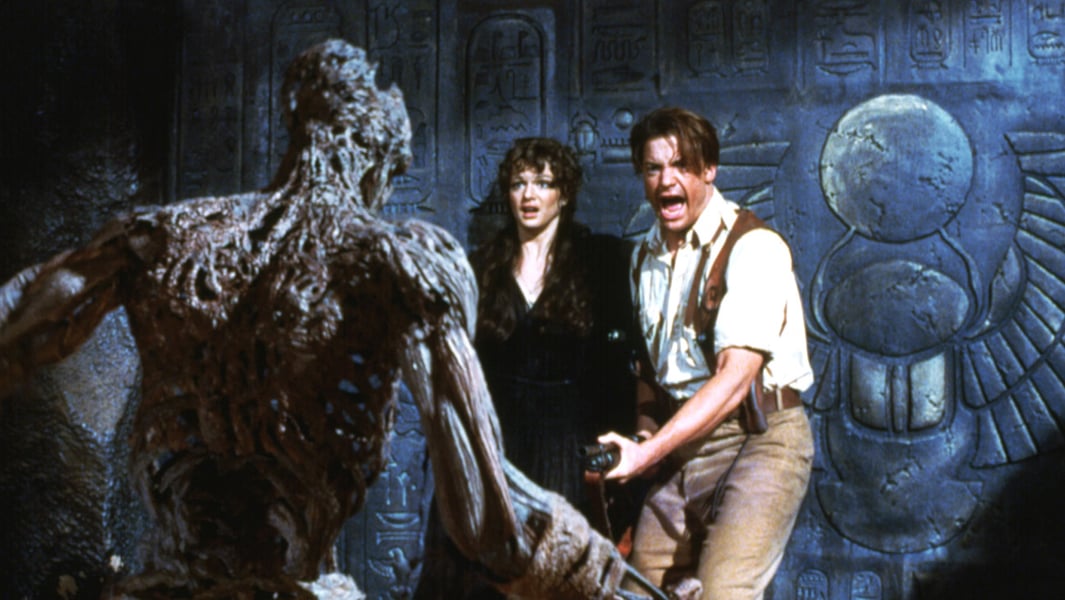 Rachel Weisz and Brendan Fraser recoil from a mummified figure in a scene from the 1999 film The Mummy