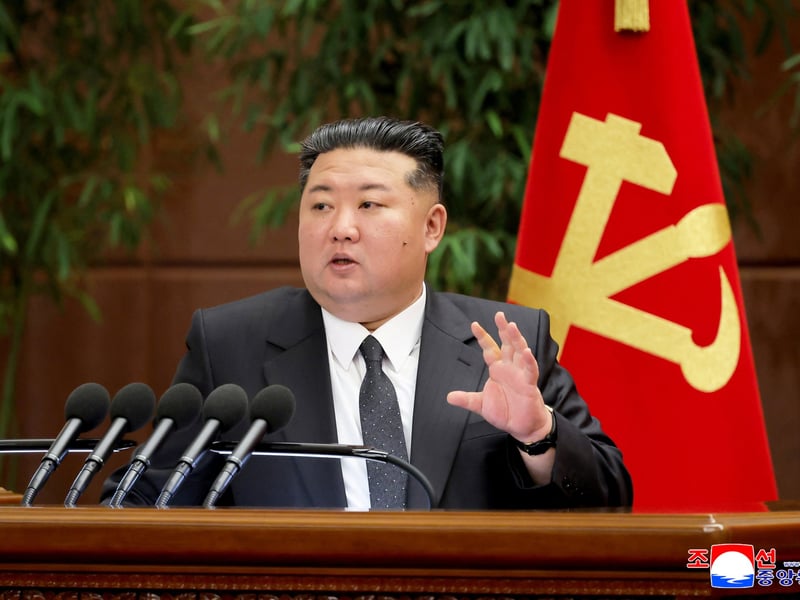 Kim Jong Un speaking at a lectern in front of a Workers' Party flag