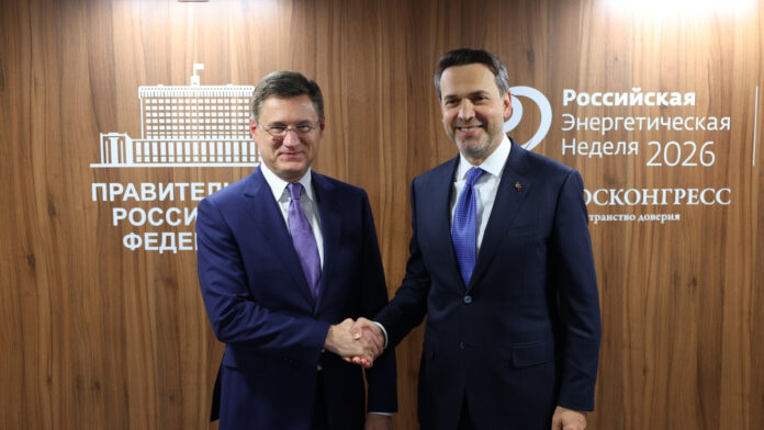 Russian Deputy Prime Minister Alexander Novak and Turkish Energy Minister Alparslan Bayraktar shaking hands in front of a Russian Energy Week 2026 backdrop