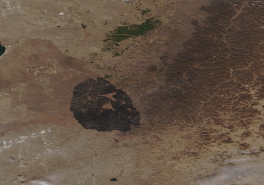 Satellite image of eastern Mongolia showing a large dark burn scar on brown steppe after the Numrug reserve fire